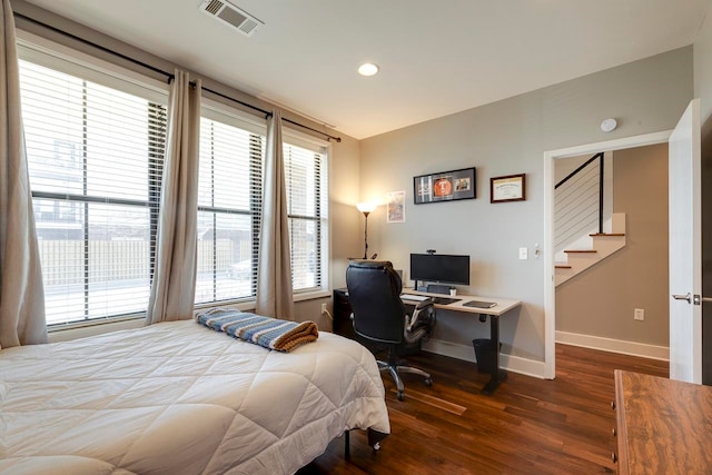 bedroom with dark wood-type flooring