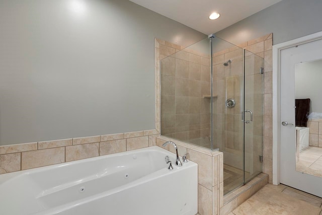 bathroom featuring tile patterned floors and independent shower and bath