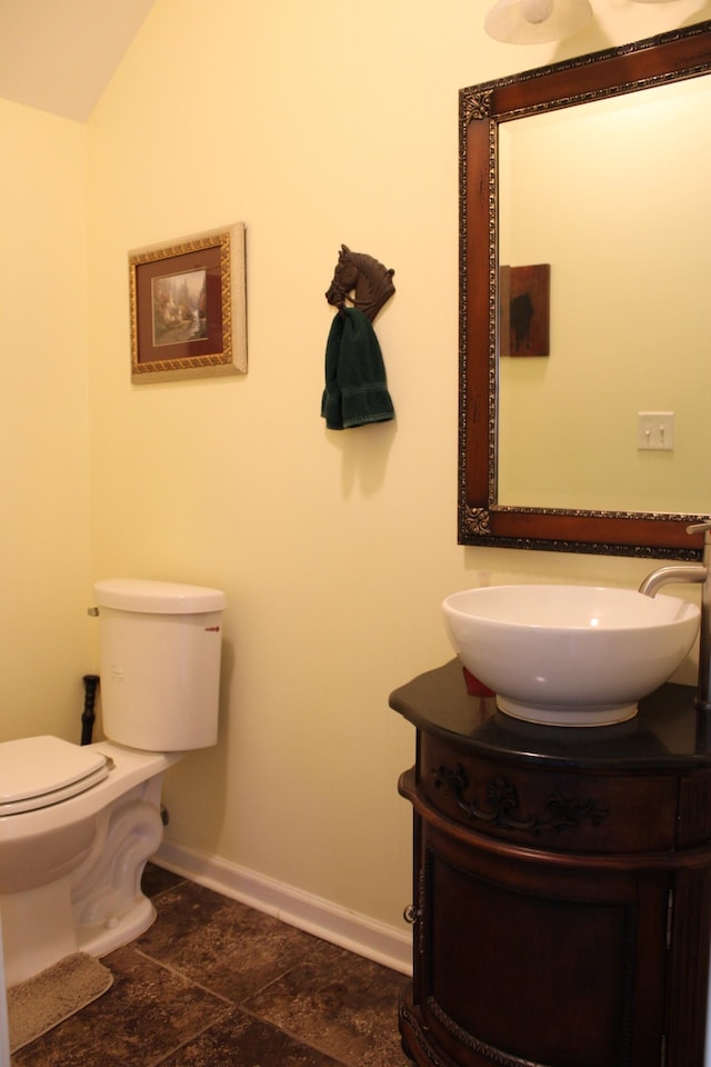 bathroom with vanity, tile floors, and toilet