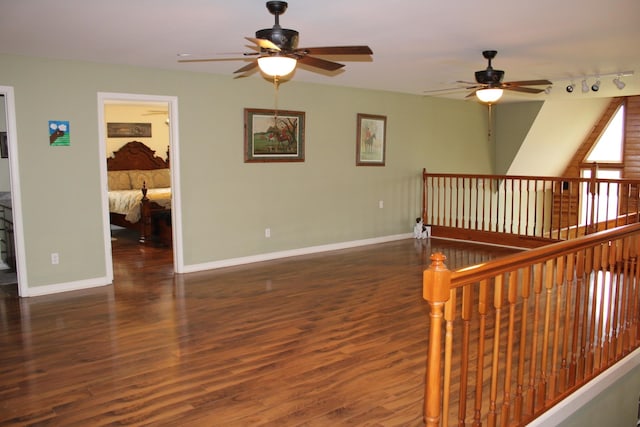 interior space with rail lighting and dark hardwood / wood-style floors