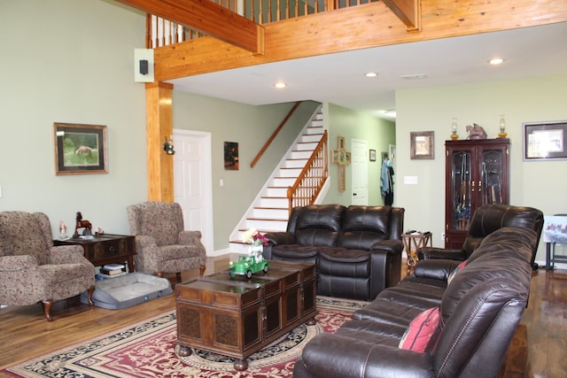 living room with a high ceiling and dark hardwood / wood-style floors