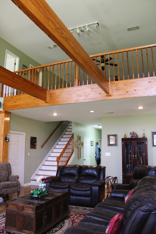 living room with a towering ceiling and track lighting