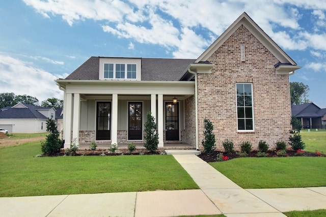 craftsman-style home featuring a porch and a front yard