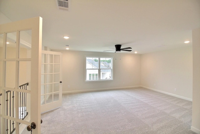 carpeted empty room with french doors and ceiling fan