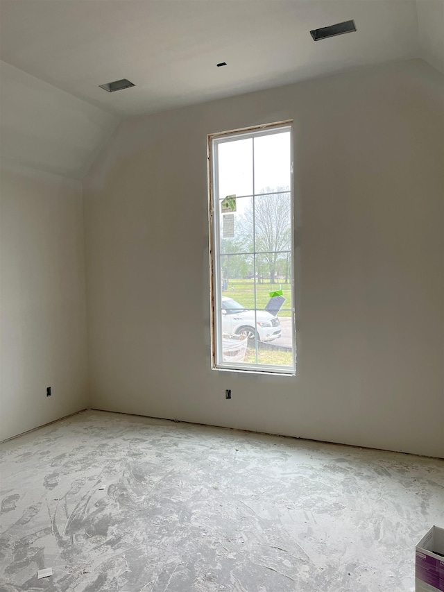 empty room with plenty of natural light and lofted ceiling