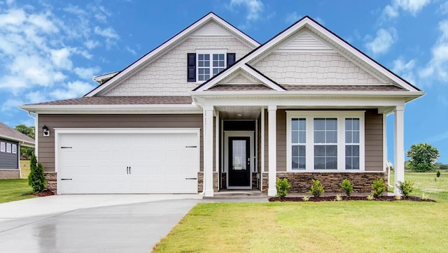 craftsman inspired home with a garage and a front yard