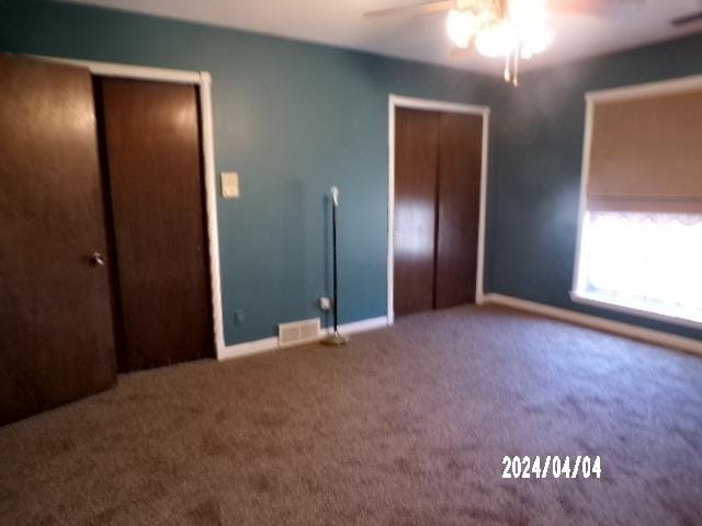 unfurnished bedroom with ceiling fan and carpet