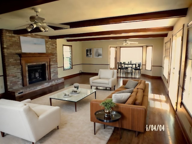 living room with ceiling fan, hardwood / wood-style flooring, and a fireplace