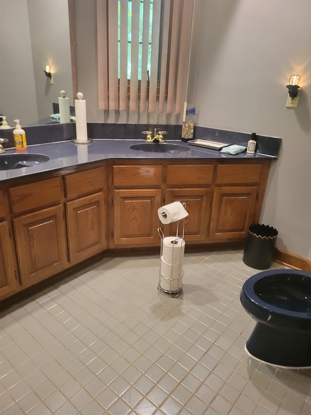 bathroom with dual bowl vanity and tile flooring