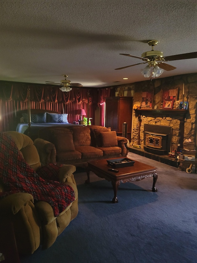 living room featuring ceiling fan, a textured ceiling, and a stone fireplace