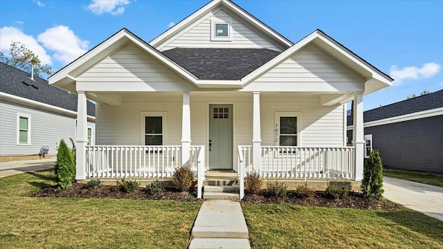 view of front of property with a front yard and covered porch