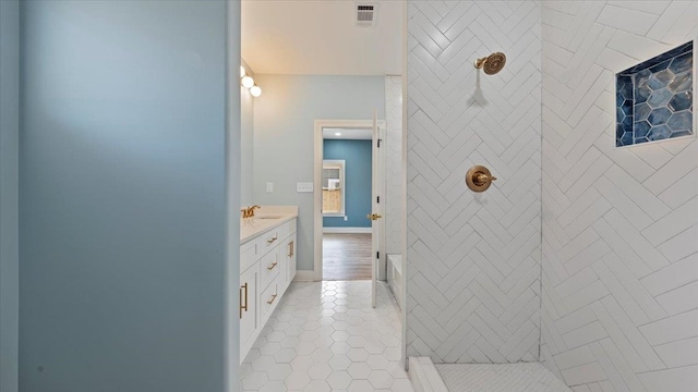 1072 Bruce St, Memphis, TN 38104 - bathroom featuring tiled shower, vanity, and tile floors