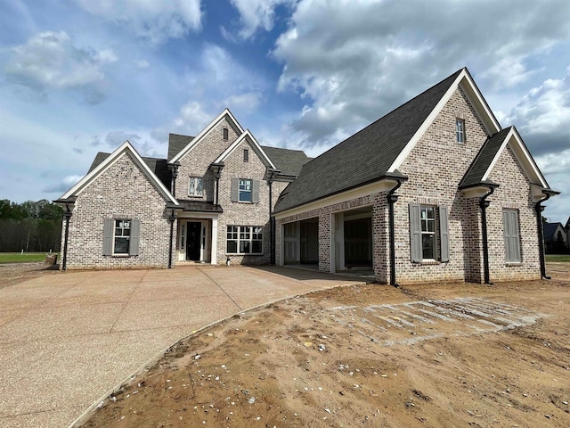 view of front of property featuring concrete driveway, brick siding, and an attached garage