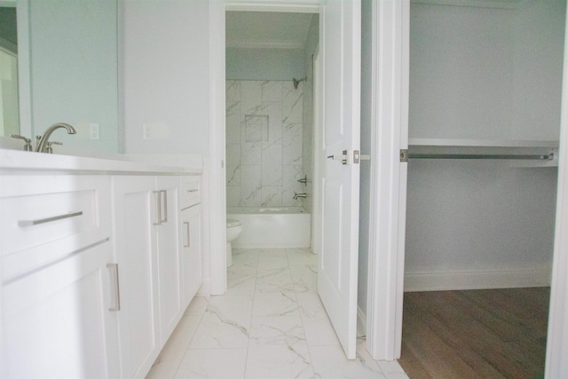 full bathroom with vanity, tiled shower / bath combo, toilet, and tile patterned floors