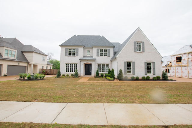 view of front of house with a garage and a front yard