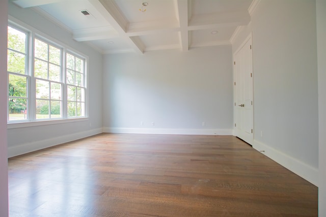 empty room featuring crown molding, beam ceiling, hardwood / wood-style floors, and coffered ceiling