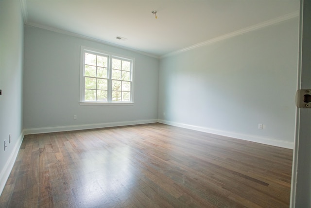 spare room with ornamental molding and wood-type flooring