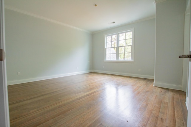 unfurnished room with light hardwood / wood-style flooring and ornamental molding