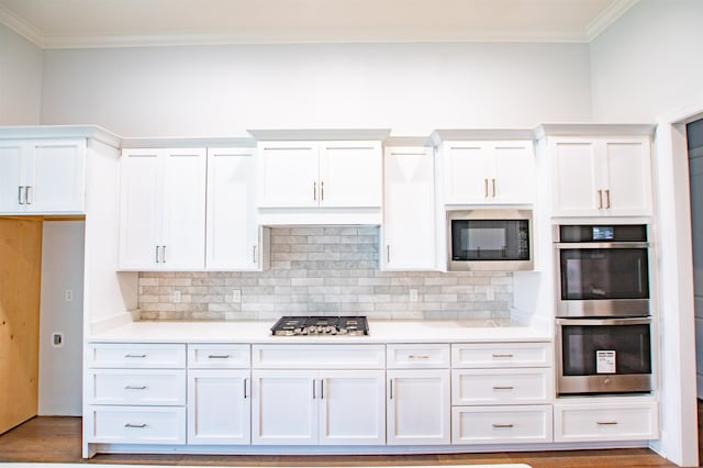 kitchen with white cabinetry, wood-type flooring, crown molding, and stainless steel appliances