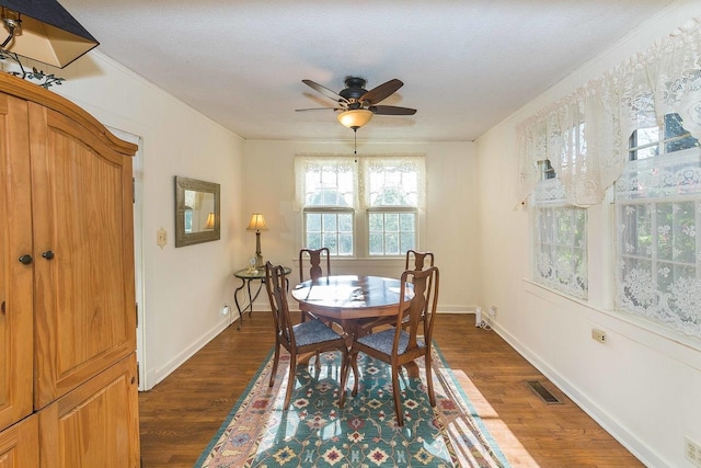 dining room featuring dark hardwood / wood-style floors, ceiling fan, and a textured ceiling