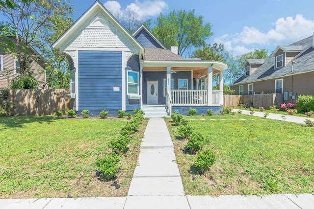 view of front of property with a porch and a front yard