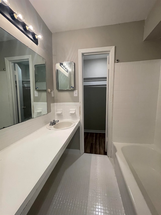 bathroom with backsplash, tile flooring, and vanity