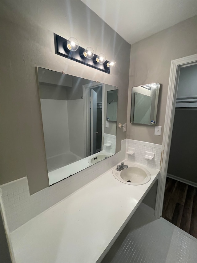 bathroom with hardwood / wood-style floors and large vanity