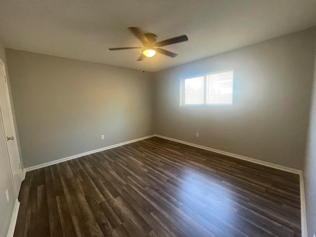 spare room with ceiling fan and dark hardwood / wood-style floors