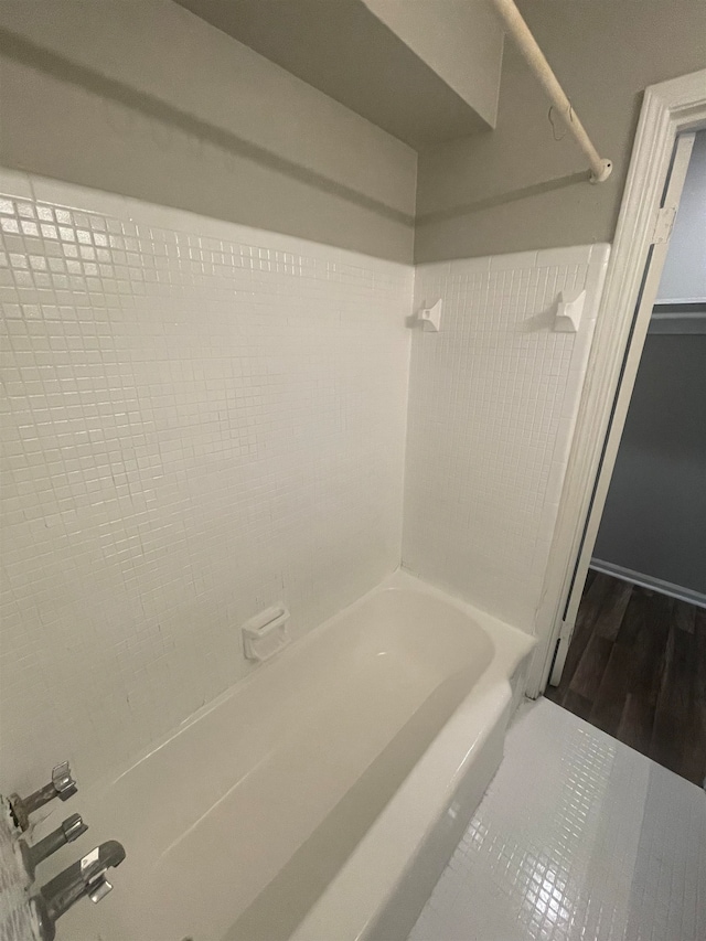 bathroom featuring hardwood / wood-style floors and tiled shower / bath