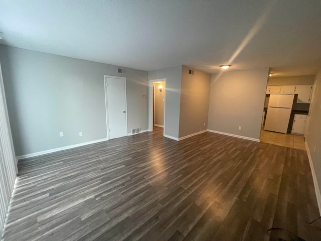 empty room with dark hardwood / wood-style floors