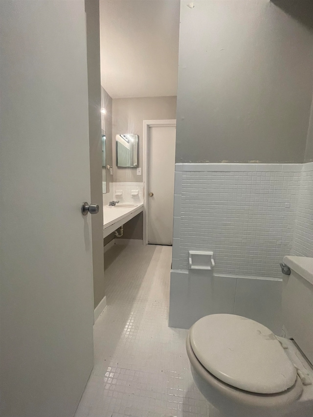 bathroom featuring tile walls, toilet, tile flooring, and vanity