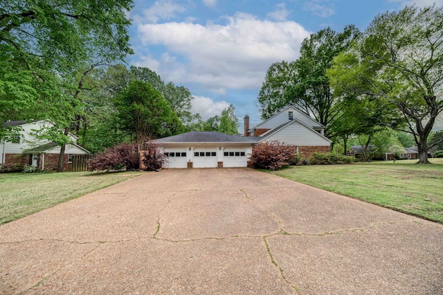 ranch-style house featuring a front lawn and a garage