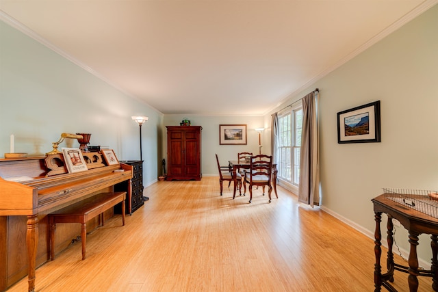 dining room featuring crown molding and light wood-type flooring