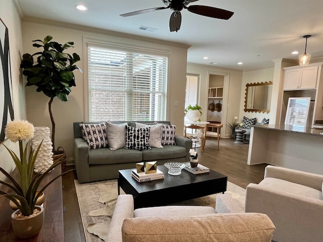 living room featuring ornamental molding, ceiling fan, and light wood-type flooring