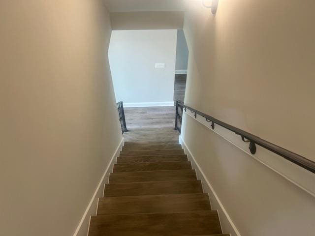 stairs featuring hardwood / wood-style floors