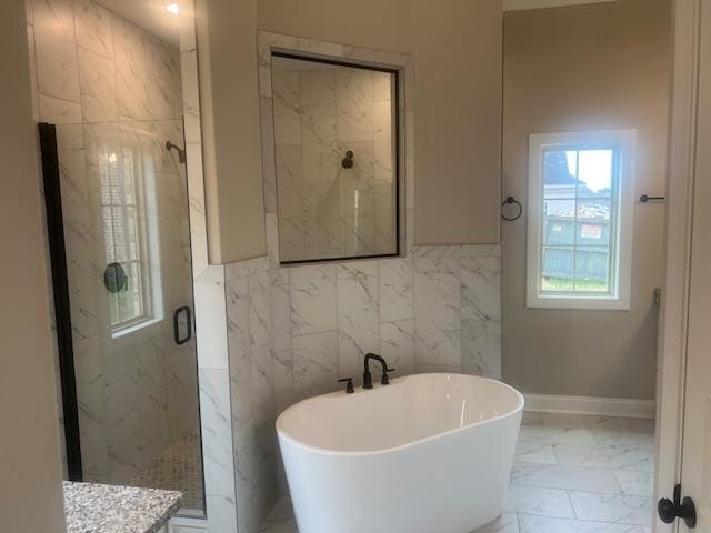 bathroom featuring tile walls, vanity, and plus walk in shower