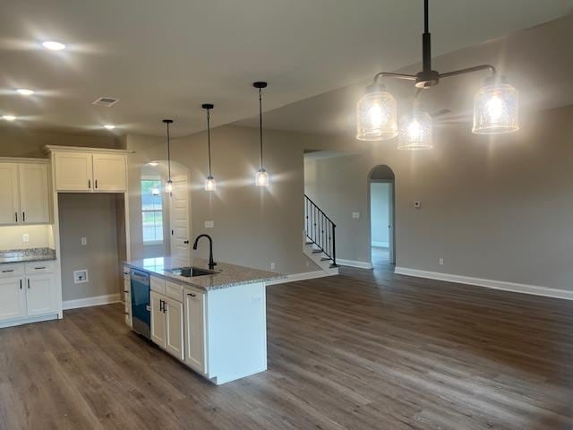 kitchen with dark wood-type flooring, sink, an island with sink, white cabinetry, and stainless steel dishwasher