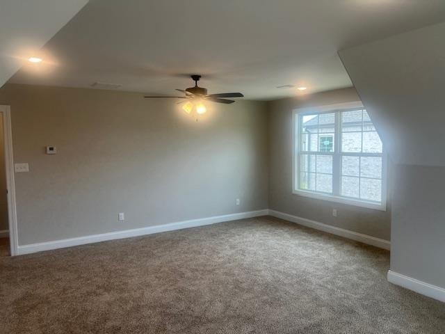 additional living space featuring carpet and ceiling fan