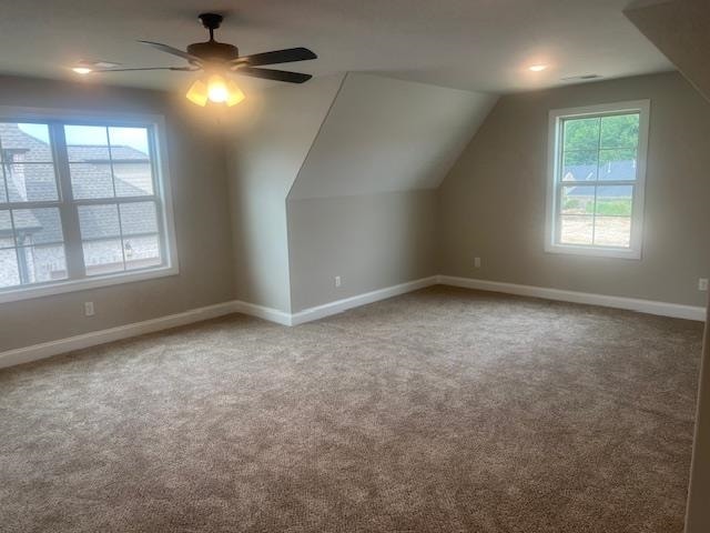 bonus room featuring ceiling fan, carpet floors, and vaulted ceiling