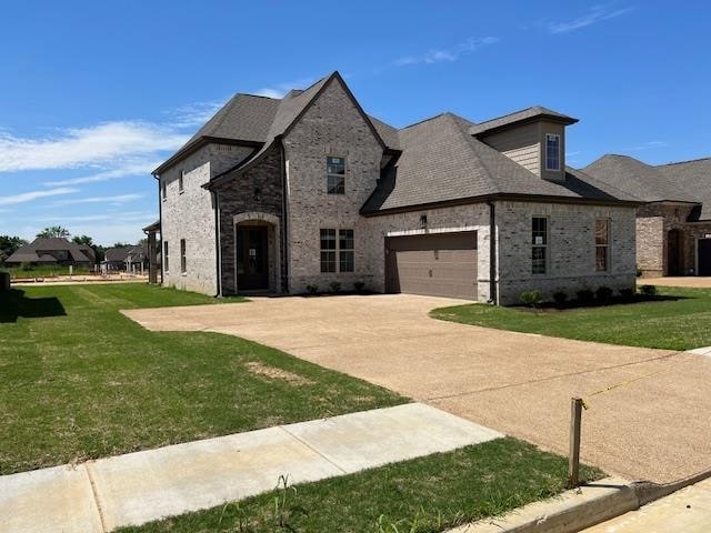 french country home featuring a front yard