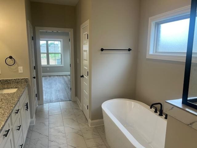 bathroom with a bath and vanity