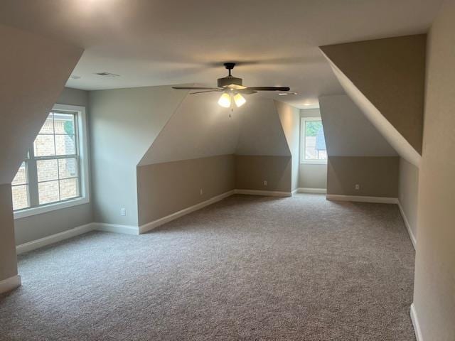 bonus room with vaulted ceiling, ceiling fan, and light colored carpet