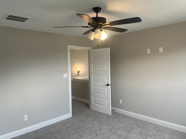 spare room with ceiling fan and carpet flooring