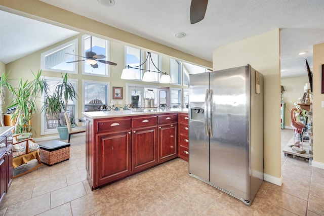 kitchen featuring hanging light fixtures, stainless steel refrigerator with ice dispenser, ceiling fan, and light tile floors