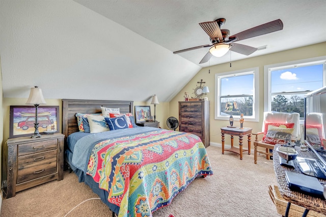 bedroom featuring vaulted ceiling, ceiling fan, light carpet, and a textured ceiling