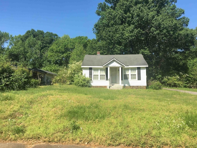 ranch-style home with a front lawn