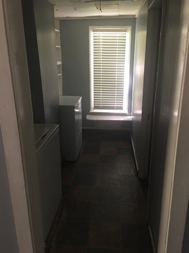 2965 Lotus Rd, Memphis, TN 38109 - hallway featuring dark tile floors and separate washer and dryer