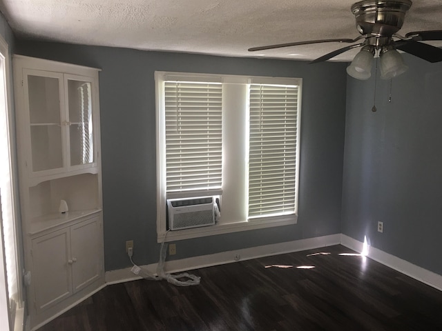 unfurnished room with dark hardwood / wood-style floors, ceiling fan, and a textured ceiling