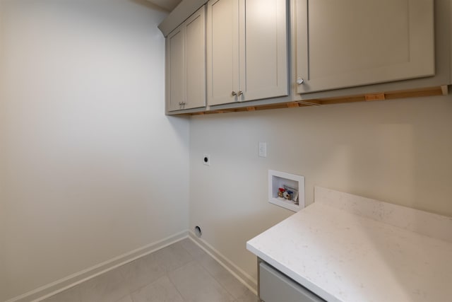 clothes washing area featuring hookup for a washing machine, cabinets, and electric dryer hookup