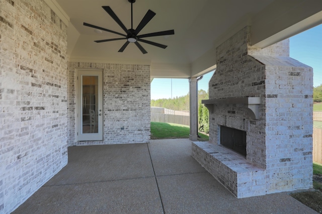 view of patio with ceiling fan and an outdoor brick fireplace